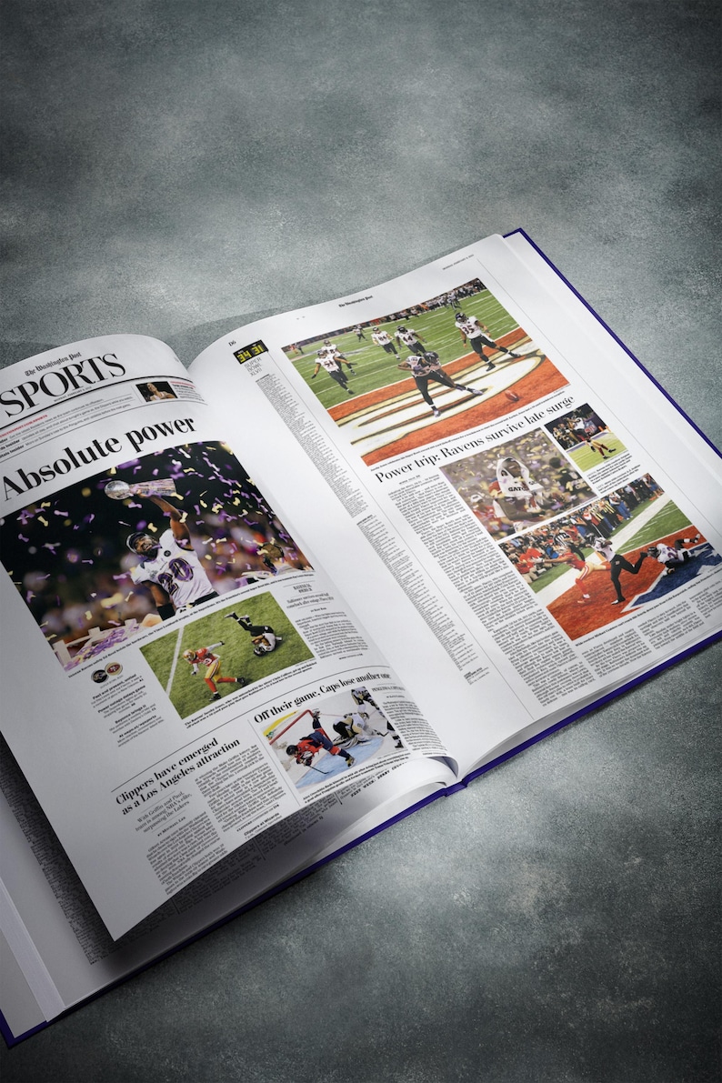 May include: An open newspaper with a sports section featuring a photo of a football player holding up a trophy. The headline reads "Absolute power".