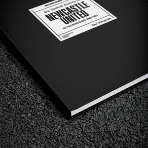 May include: A black hardback book with a white label on the front. The label has the text "HISTORIC NEWSPAPERS The Football History of NEWCASTLE UNITED AS TOLD IN HEADLINES SINCE 1993 PRESENTED TO KOSTAS The Telegraph".
