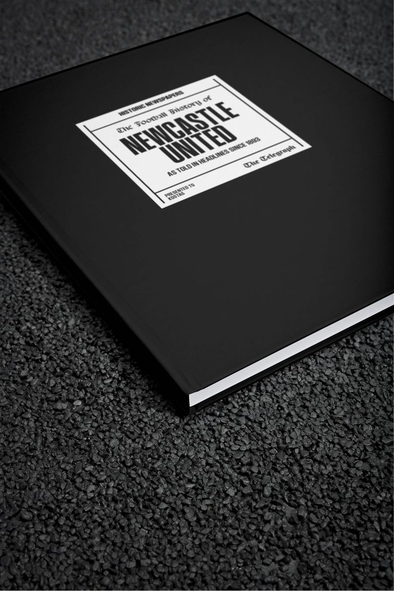 May include: A black hardback book with a white label on the front. The label has the text "HISTORIC NEWSPAPERS The Football History of NEWCASTLE UNITED AS TOLD IN HEADLINES SINCE 1993 PRESENTED TO KOSTAS The Telegraph".