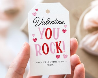 May include: White gift tag with pink and red hearts and the text "Valentine, You Rock! Happy Valentine's Day! From:"