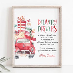 May include: A watercolor illustration of a red vintage truck with a stack of wrapped gifts on the back. The truck is driving towards the viewer. The text "DELIVERY DRIVERS" is written in red and green letters above the truck. The text below the truck reads "A sincere thank you for all you do & wishing you a Happy Holiday season from us to you! Please take some goodies for the road! Merry Christmas."