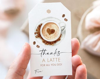 May include: A white gift tag with a watercolor illustration of a cup of coffee with a heart design in the foam. The text on the tag reads "Thanks a latte for all you do!" and "From:"