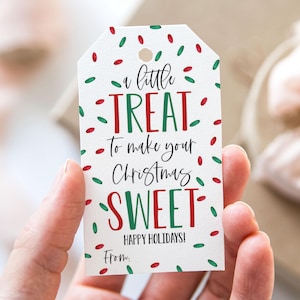 May include: A white gift tag with red and green confetti. The tag says "a little TREAT to make your Christmas SWEET" with the words "Happy Holidays!" and "From:" at the bottom.