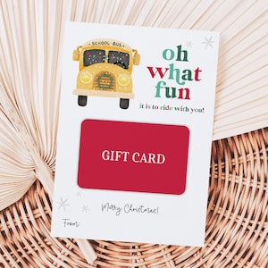 Könnte beinhalten: Eine weiße Geschenkkarte mit einem roten Geschenkkarteneinsatz. Die Karte zeigt eine gelbe Schulbus-Illustration und den Text "oh what fun it is to ride with you!". Die Worte "Merry Christmas!" sind ebenfalls auf der Karte aufgedruckt.