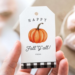 May include: White gift tag with a watercolor orange pumpkin illustration and the text "HAPPY Fall Y'all!" in black script. The tag has a black and white checkered border and a hole at the top for hanging. The word "FROM:" is printed below the text.