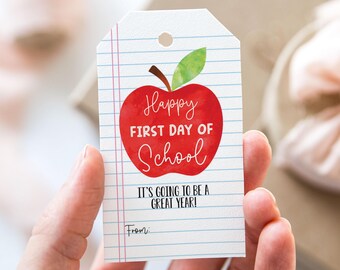 May include: A white gift tag with red and green watercolor apple design. The text reads "Happy First Day of School" and "It's going to be a great year!" with a line for "From:".