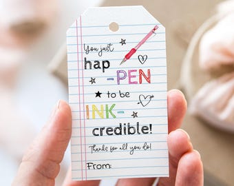 May include: A colorful gift tag with a handwritten message that reads "You just hap-PEN to be INK-credible! Thanks for all you do!" with a pen, stars, and hearts drawn around the text. The tag has a line at the bottom for a name.