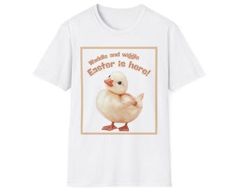 May include: White t-shirt with a brown rectangle featuring a yellow duckling and the text "Waddle and wiggle Easter is here!"