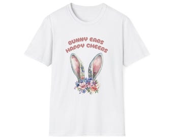 May include: White t-shirt featuring a watercolor design of bunny ears with a floral arrangement and the text "Bunny Ears Happy Cheers" in pink. The bunny ears are light blue and gray.