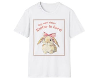 May include: White t-shirt with a pink bunny wearing a pink bow and the text "Hop with cheer Easter is here!" in a pink box.