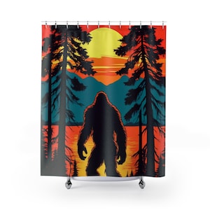 May include: A Bigfoot-themed shower curtain featuring a silhouette of the creature in a forest scene. The design includes a sunset with orange, yellow, and teal hues, with tall trees framing the figure. The curtain is made of a durable material.