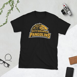 May include: Black t-shirt with a yellow and black graphic of a pangolin with the text "Pittsburgh Pangolins".