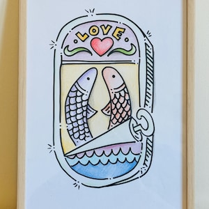 May include: Framed art print with a quirky illustration of two fish in a sardine can, facing each other. The word "LOVE" is above a red heart. The artwork is in a wooden frame.