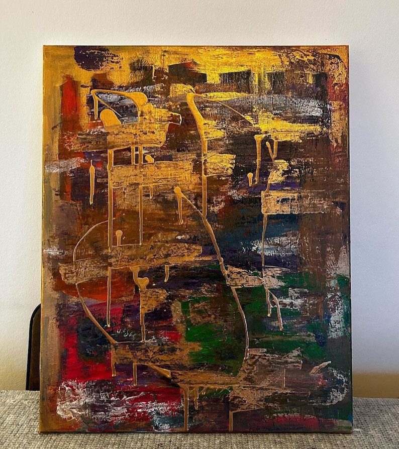 dynamic earth tones and gold streaks on canvas, creating a bold, expressive impact
