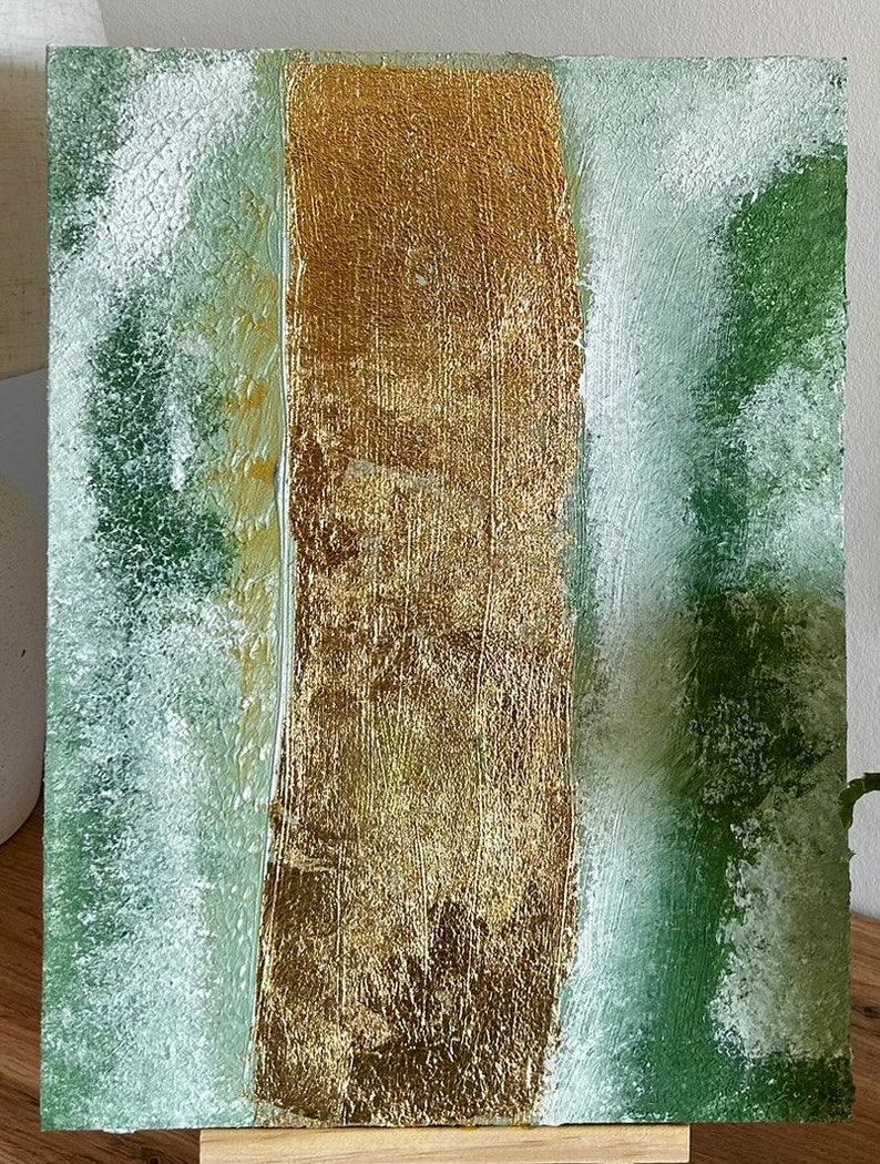 Abstract acrylic painting with textured green and gold leaf on canvas, creating a natural, organic feel.