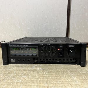 May include: Black Clarion digital surround mixing amplifier MA-5500A. The front panel features a display, multiple knobs, and input options. The amplifier has a perforated top and a large volume control knob.
