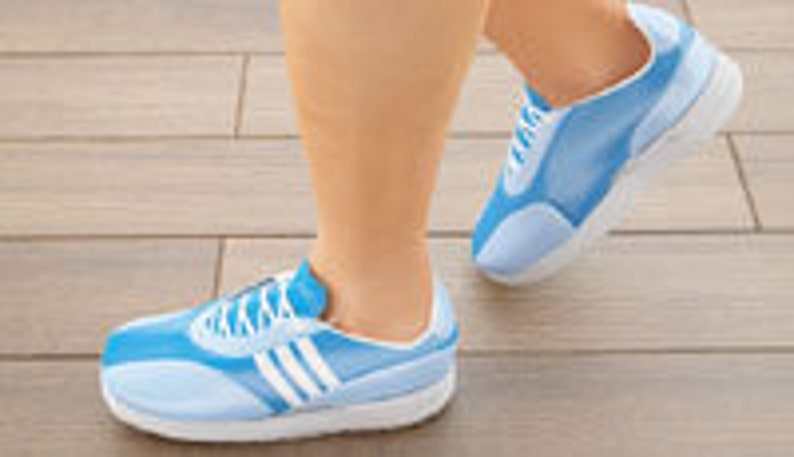 May include: Light blue athletic shoes with white accents and laces. The shoes have a white sole and are designed for running or walking. The image shows the shoes on a person's feet, with one foot in mid-stride.