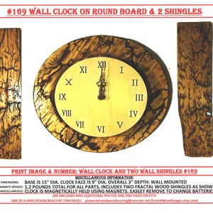 May include: A round wooden wall clock with Roman numerals, surrounded by a decorative wood grain border. The clock face is light-colored, and the hands are black. Two matching wood shingles flank the clock. The text "#169 WALL CLOCK ON ROUND BOARD & 2 SHINGLES" is at the top.