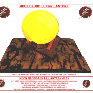 May include: A 3.1 inch moon globe on a wooden stand with a fractal burned design. The stand is made of pine plywood and measures 6.5 inches wide by 7.5 inches long. The globe is mounted on the stand and is 1/4 inch thick. The stand is wall mounted. The text "MOON GLOBE-LUNAR LANTERN #141" is printed on the image.