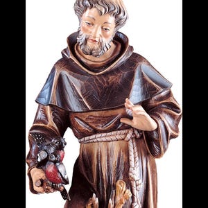 statue of saint francis, wooden sculpture from Val Gardena. The statue is carved in maple wood and hand painted