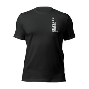 May include: Black crew neck t-shirt with white text. The text reads "FOCUS, BREATHE, EXECUTE" vertically down the left side of the shirt. The shirt is made of a soft material and has short sleeves.