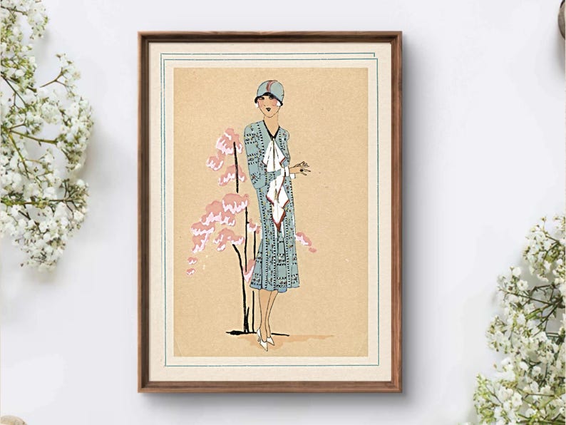 1920s Art Deco fashion illustration from Tres Parisien magazine showing a stylish woman in powder blue dress with white tie collar and matching cloche hat, standing beside pink cherry blossoms. Digital wall art from French vintage fashion publication.