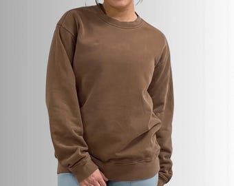 May include: A brown long-sleeved sweatshirt with a crew neck.