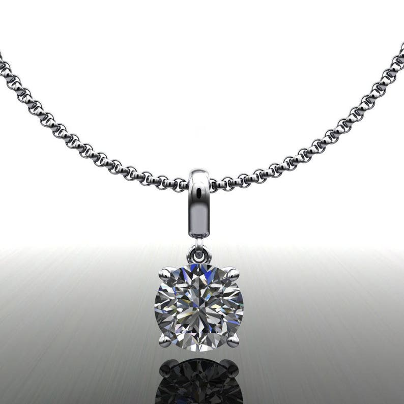 May include: A silver chain necklace with a pendant featuring a large, round, clear diamond.