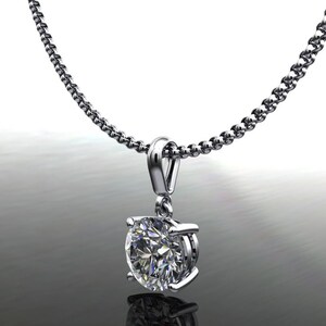 May include: A silver chain necklace with a round, clear diamond pendant.