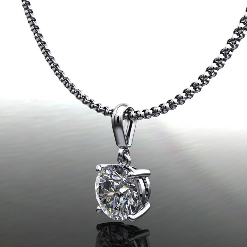 May include: A silver chain necklace with a round, clear diamond pendant.