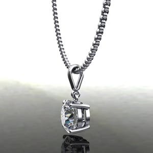 May include: A silver chain necklace with a round, clear diamond pendant.