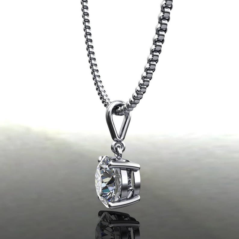 May include: A silver chain necklace with a round, clear diamond pendant.