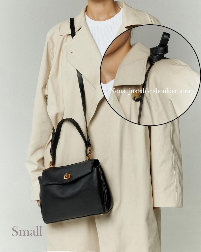 May include: A small, black handbag with a gold-colored clasp and hardware. The bag has a nonadjustable shoulder strap and a top handle. The word "Small" is printed at the bottom of the image. The bag is worn over a beige trench coat.