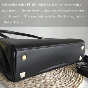 May include: A black leather handbag with gold-colored studs on the bottom. The bag has a top handle and a shoulder strap. The text in the image describes the material as split leather with a PU film.