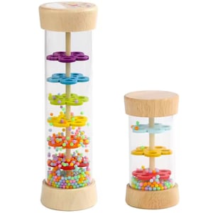 May include: Two wooden musical instruments with clear tubes filled with colorful beads and wooden flower shapes. The larger instrument has five flower shapes and the smaller instrument has three flower shapes.