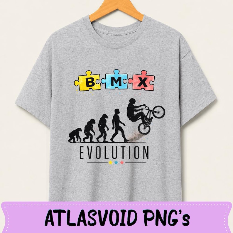 May include: A light gray t-shirt featuring a BMX-themed design. The design includes puzzle pieces spelling "BMX" above a silhouette depicting the evolution of man, culminating in a BMX rider performing a trick. The word "EVOLUTION" is printed below.