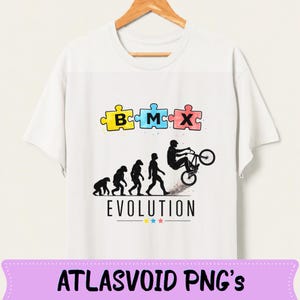 May include: White t-shirt featuring a BMX-themed design. The graphic includes puzzle pieces spelling "BMX", an evolution of man illustration, and a BMX rider. The word "EVOLUTION" is printed below the illustration.