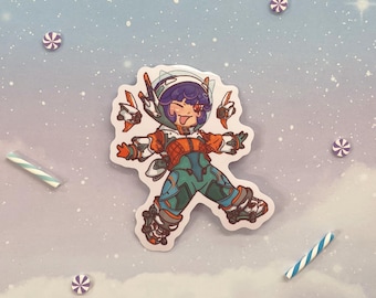 May include: A colorful sticker featuring a cartoon character wearing a white helmet and orange and green clothing. The character is in a dynamic pose with arms outstretched and legs spread wide. The sticker has a white background and is printed on a glossy surface.