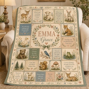 May include: A personalized quilt featuring a central floral wreath with the name Emma Grace, surrounded by grid panels displaying illustrations of a deer, lamb, rabbit, fox, duck, bear, bluebird, frog, and squirrel alongside various Bible verses.