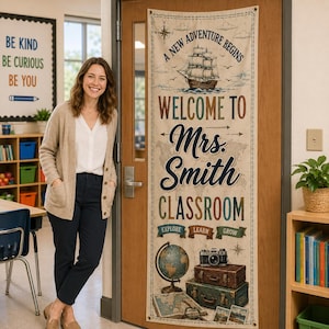 May include: A vertical fabric banner hanging on a door featuring a nautical theme with a sailing ship, a globe, and stacked vintage suitcases. The text reads A NEW ADVENTURE BEGINS, WELCOME TO Mrs. Smith CLASSROOM, and EXPLORE LEARN GROW.