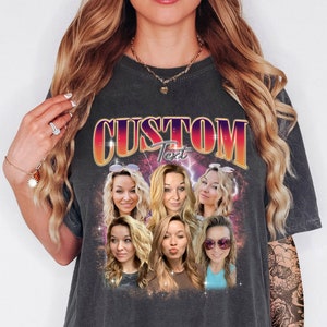 May include: Dark gray t-shirt with a retro design featuring the word "CUSTOM" in orange and purple, with the word "Text" below. The shirt has a collage of six portraits of a woman with blonde hair.