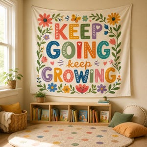 May include: A rectangular wall tapestry featuring a cream background with a colorful floral border and the text KEEP GOING keep GROWING in large, multi-colored block letters. The design includes various flowers, leaves, and a small butterfly.
