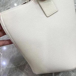 May include: A white leather tote bag with a textured surface.