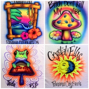 May include: Four different designs for t-shirts featuring colorful graphics. The first design features a sunset scene with a wave and palm trees inside a wooden frame. The second design features a psychedelic mushroom with the text "Bitch Don't Kill My Vibe". The third design features a green frog sitting on a mushroom with purple swirls in the background. The fourth design features a sun and moon with faces and the text "Crystal & Elly's Panama City Beach".