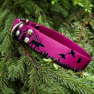 May include: A pink dog collar featuring a black silhouette design of a mountain scene with birds flying over it.