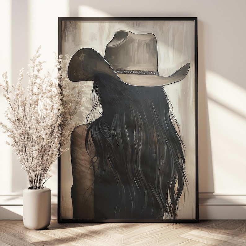 May include: A painting of a woman with long dark hair wearing a brown cowboy hat. The background is a light beige color.
