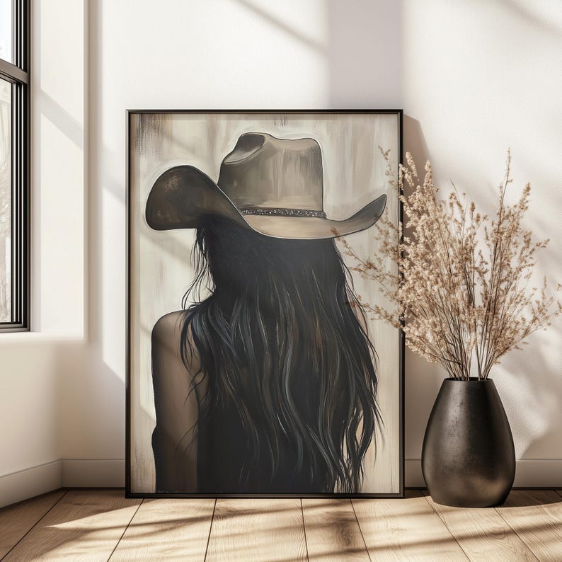 May include: A painting of a woman with long dark hair wearing a brown cowboy hat. The woman is facing away from the viewer and her back is turned. The background is a light brown color.
