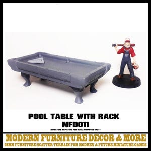 May include: A gray miniature pool table with a triangular rack on the surface, supported by four curved legs. Beside it stands a painted miniature figure wearing a red shirt and blue overalls, holding a baseball bat. Text reads POOL TABLE WITH RACK MFD011.