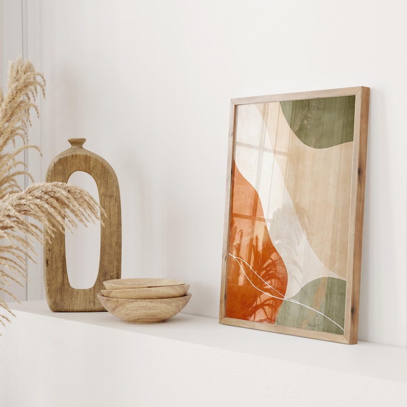 A refined piece of abstract Japandi wall art, showcasing calming organic shapes in shades of serene green, warm orange, and soft beige. This ready-to-print art piece comes in all common sizes, perfect for adding a touch of brightness to walls.