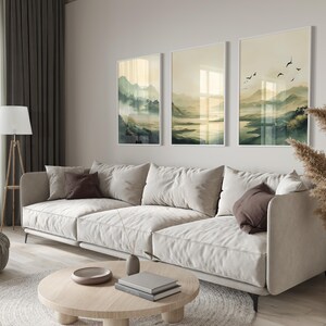 Japandi wall art featuring an olive-green, misty mountain landscape with a serene lake and a traditional Japanese town. This set of three is inspired by Japandi minimalism, this vertical wall art is ready to be printed in all common sizes.